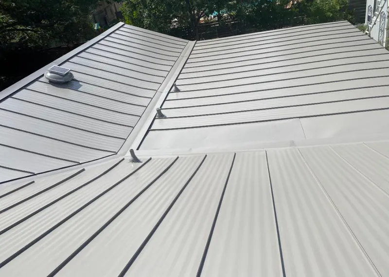 Solar attic fan installed on a metal roof for Roof Ventilation in Tuckahoe